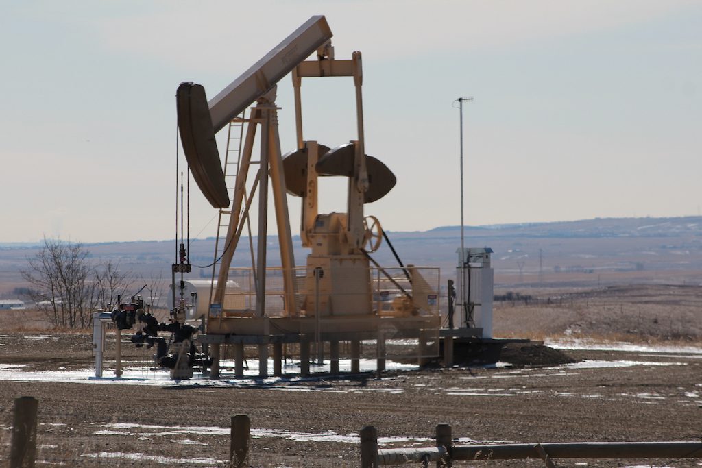 How could geothermal energy be derived from oil wells?